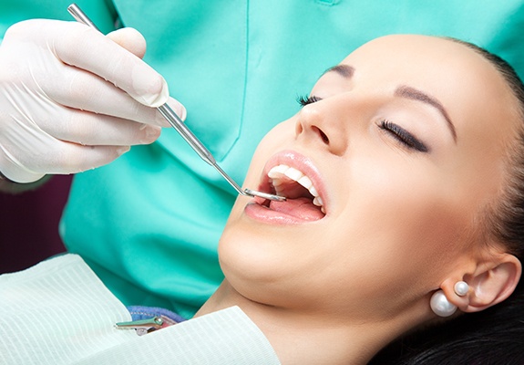 Patient receiving dental checkup and teeth cleaning