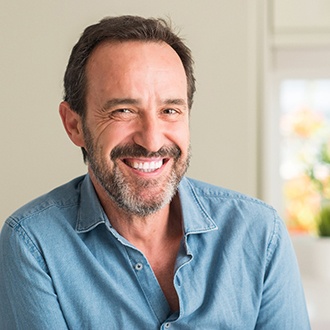 man smiling after getting dental implants 