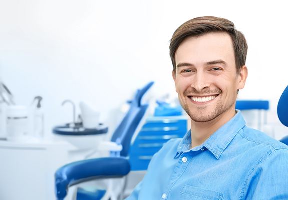 Male patient in dentist’s office smiling after dental cleaning in Zionsville