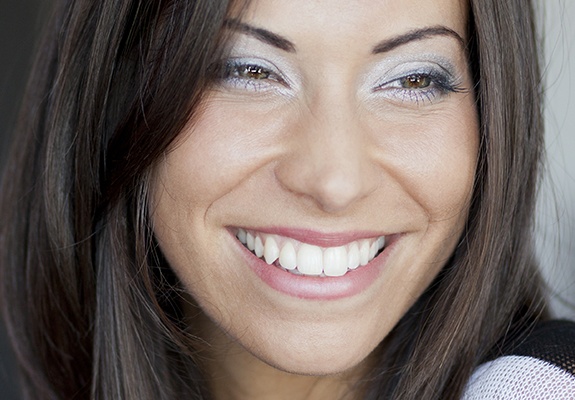 Woman with flawless smile after crown lengthening