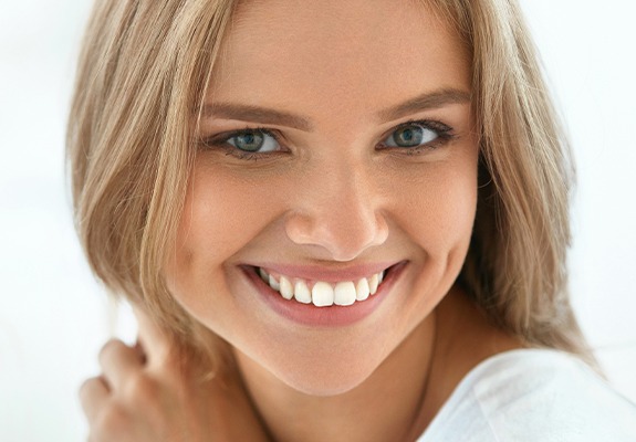 Woman with flawless smile after teeth whitening