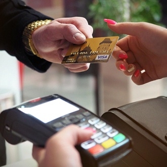 Man handing credit card to woman