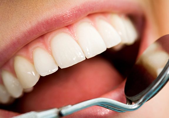 Dentist examining smile after crown lengthening