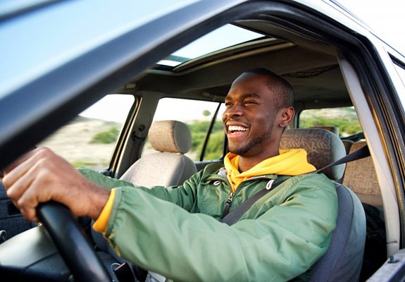 Man smiles while driving