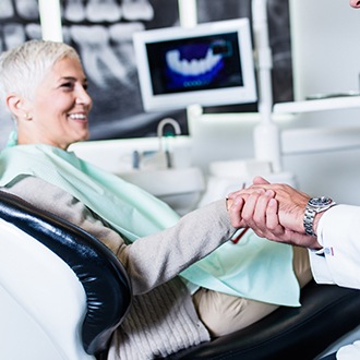 Woman with dental implants talking to dentist