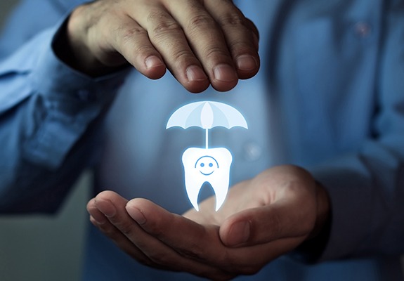 Hand holding an animated tooth under an umbrella