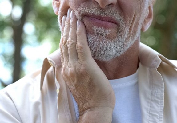 Man rubbing his jaw