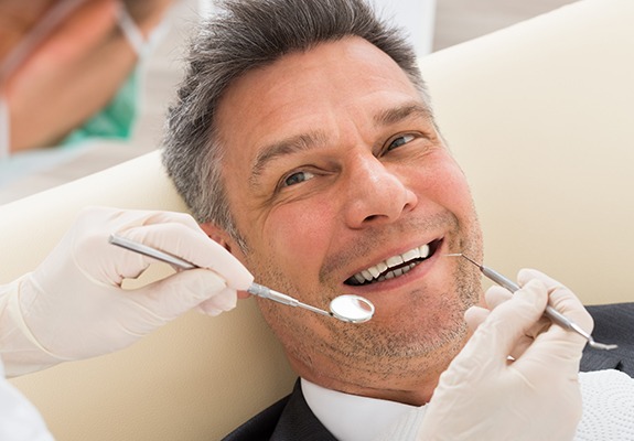 Patient smiling during scaling and root planing