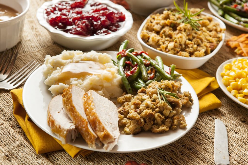 Thanksgiving spread with turkey, stuffing, and green beans