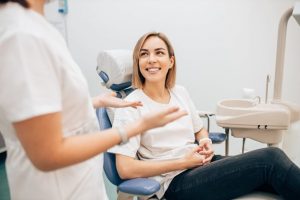 a patient smiling and visiting their dentist