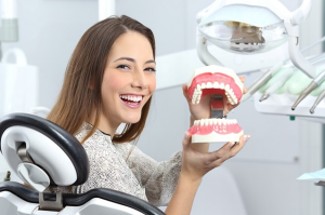 a patient visiting their dentist to receive dentures