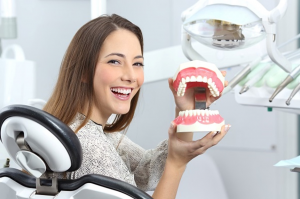 a patient visiting their dentist to receive dentures 