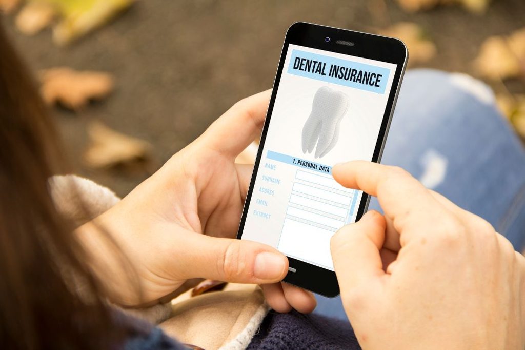 A woman looking at a dental insurance app.